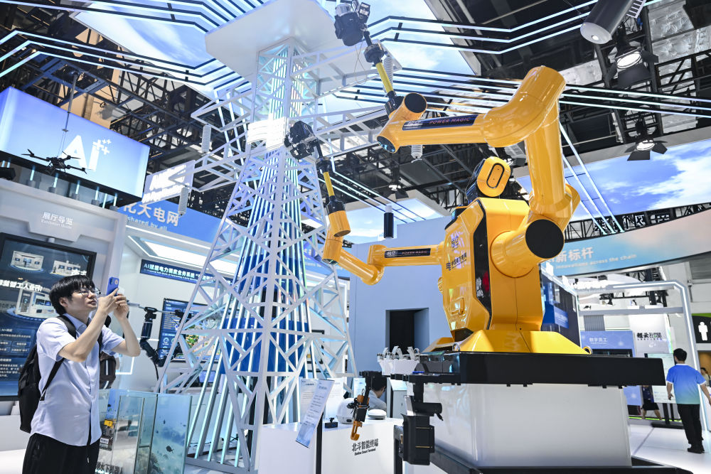 7月28日，在2025世界人工智能大会上，参观者在中国南方电网展区拍摄“悟空”带电作业机器人。新华社记者 陈浩明 摄.jpeg