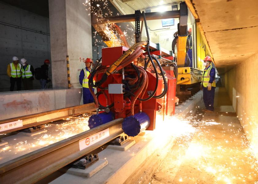 昨天上午，轨道交通22号线陈家镇车站内，中铁五局作业人员完成最后一对钢轨接头焊接.jpg